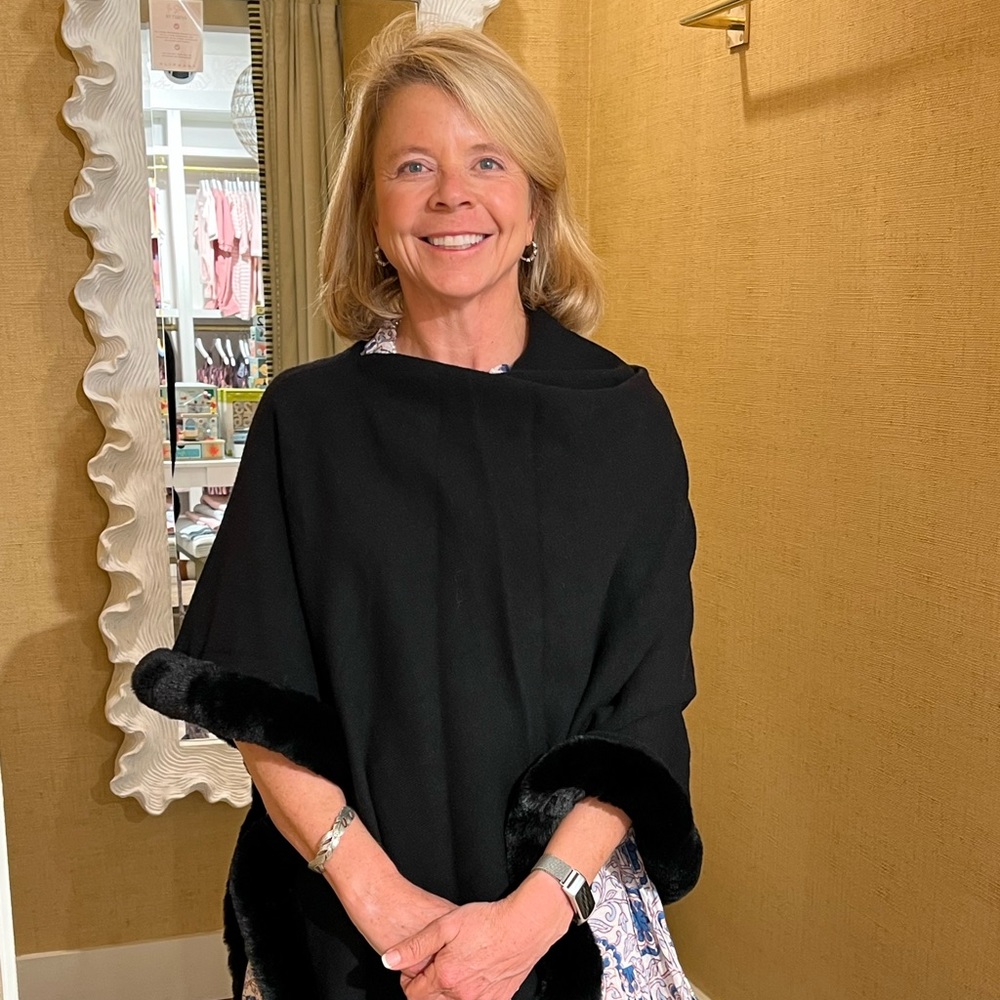Black Etcetera poncho with faux fur trim.